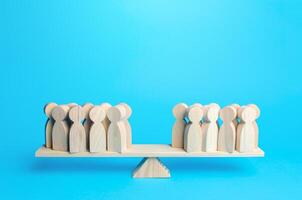 People are in opposite positions on scales. Division of society in opinion. The stumbling block in mutual understanding, no consolidation around problem solving. Political democratic elections photo