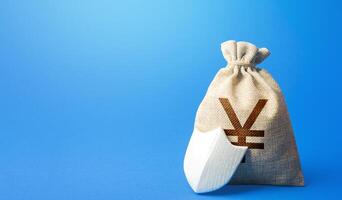 Yen Yuan money bag and protection shield. Ease doing business. Guaranteed deposits insurance compensation. Investment protection. Strength of the financial system. Sustainable banks. photo