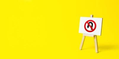 Easel with no turning back traffic sign on a yellow background. Assertiveness and striving, moving forward without retreating. Go to the goal, don't stop. Finish things. There is no way back. photo