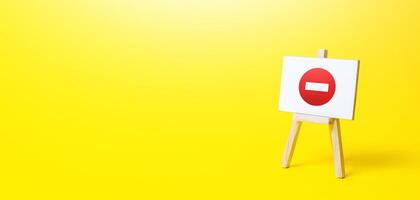 Easel with no entry symbol. Prohibition of actions and operations, restricted area. Ban and sanctions. Wrong direction. Failed strategy. Inaccessibility, taboo. Blocking, imposing restrictions. photo