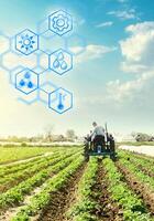 A farmer drives a tractor across potato plantation field and hexagons with innovations. Science of agronomy. Improvement in quality and yield growth. Reducing the impact on the environment. photo