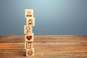 Block tower with medical icons symbols. Healthcare and medical Insurance concept. Supplies, equipment and specialists for the normal functioning of hospitals in the fight against the pandemic. photo