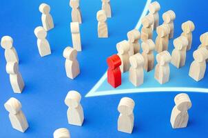 Red leader with followers in arrow formation direction breaks through the crowd. Breaking new ground. Society consolidation. Reform movement, political force. Commitment to change. Public response. photo
