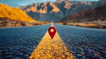 Red location pin marker stands out against yellow road line on empty desert highway, with mountain silhouettes and vibrant blue sky creating cinematic travel scene. marker photo