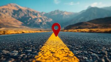 Red location pin marker stands out against yellow road line on empty desert highway, with mountain silhouettes and vibrant blue sky creating cinematic travel scene. direction photo
