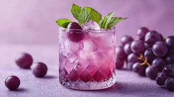 Refreshing purple cocktail garnished with mint and grapes sparkles in crystalline glass, capturing dewdrops effect against soft lavender backdrop, presented with high-key lighting an luxury styling photo