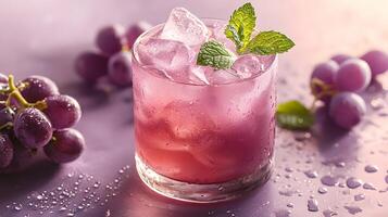 Refreshing purple cocktail garnished with mint and grapes sparkles in crystalline glass, capturing dewdrops effect against soft lavender backdrop, presented with highkey lighting and luxury styling photo