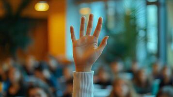 White-sleeved hand raises in classroom environment, representing participation and volunteering against blurred background with warm lighting and educational context. knowledge photo