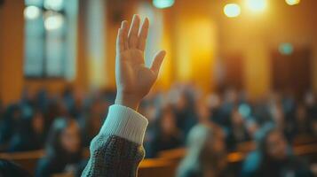 White-sleeved hand raises in classroom environment, representing participation and volunteering against blurred background with warm lighting and educational context. involvement photo