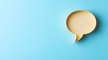 Light blue background features speech bubble cutout in paper craft style, presenting communication concept with beige balloon shape and soft shadow effects. communication photo