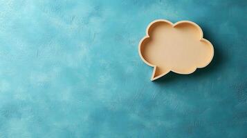 Light blue background features speech bubble cutout in paper craft style, presenting communication concept with beige balloon shape and soft shadow effects. modern photo