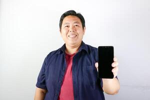 Smiling Man with showing blank screen his smartphone, Communication and technology concept. photo