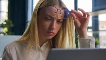 Confused Caucasian businesswoman in eyeglasses girl business woman employee take off glasses problem bad vision blurry sight reading on laptop overwork in office check eyesight ophthalmology service photo