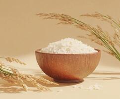 Natural white rice displayed in a wooden bowl with wheat stalks against a neutral background photo