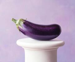 Purple eggplant resting on a white pedestal against a soft pastel background photo