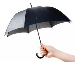 Hand holding a black umbrella to shield against rain in a wet environment photo