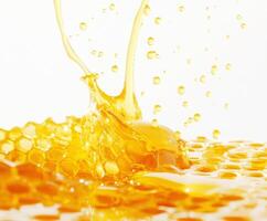 Golden honey splashes over honeycomb with vibrant droplets reflecting sunlight photo