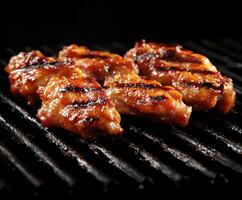 Grilled chicken wings with barbecue glaze cooked on a charcoal grill at a summer cookout photo