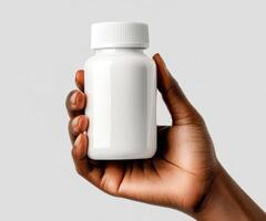 Hand holding a plain white bottle against a neutral background showcasing a focus on health and wellness photo