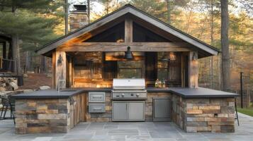 Modern outdoor kitchen featuring stainless steel grill and stone countertop in rustic setting photo