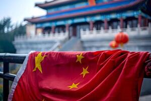 Chinese flag hanging on railing with traditional building in background photo