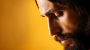 Introspective man with beard gazing thoughtfully against a warm orange backdrop photo