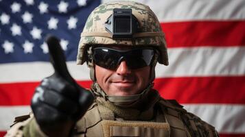 Soldier giving a thumbs up in front of an American flag during a military event photo
