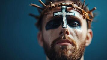 Man with crown of thorns and face paint captures a powerful moment of expression in artistic performance photo