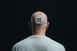 Man with shaved head displays QR code on the back of his head against a dark background photo
