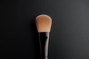 High-quality makeup brush resting against a dark background showcasing its soft bristles and sleek handle design for beauty enthusiasts photo