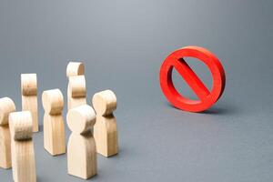 People look at red prohibition sign NO. Restriction of rights and freedoms, legislative prohibition laws and rules. Taboo, rejection. Abolition of restrictive measures under society pressure. photo