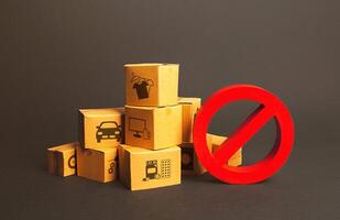 Cardboard boxes and red prohibition symbol NO. Import restriction, ban export goods. Lack of goods, deficit shortage, Out of stock. Embargo sanctions, trade wars. Border closure, quarantine isolation photo