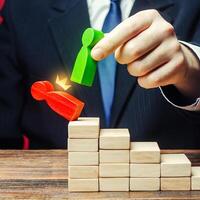 A businessman replaces an employee with a new one on career ladder. Head Offset. Business optimization. Strengthening change of power, capture control of business. Fight corruption. System recovery. photo