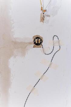 A detailed closeup view of a light switch affixed to a wall surface, showcasing its design and features in a way that emphasizes the importance of such a common yet essential device photo