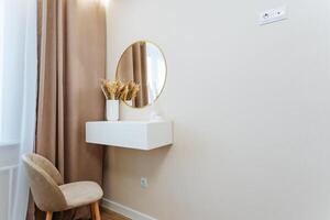 In the room, there is a chair positioned neatly along with a mirror that reflects the surrounding space, adding depth to the interior design and enhancing the overall ambiance photo