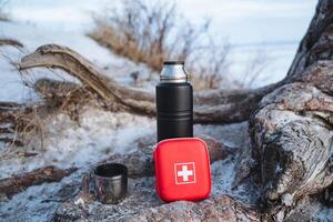 Essentials for a Winter Outdoor Adventure An insulated flask and a wellstocked first aid kit are crucial while enjoying the snowy landscape during your excursions photo