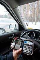 A person is seated comfortably in their vehicle, at ease and ready for emergencies, confidently holding a first aid kit for unexpected medical situations while traveling photo