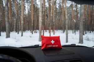 A wellstocked first aid kit is conveniently placed on the dashboard of a car, ensuring that the driver and passengers can quickly access medical supplies if needed during their journey photo