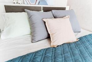 Comfortable hardwood bed frame with pillows and quilt in a rectangular shape photo