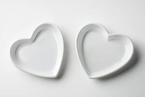 Two Heart-Shaped White Ceramic Bowls on a Minimalist White Background photo