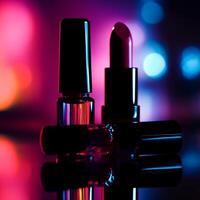 Dark silhouette of nail polish bottles and lipsticks placed on a reflective surface with soft light. photo
