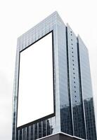 white vertical large LED display billboard on tower building photo