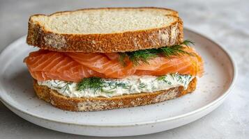 Hearty sandwich. Salmon sandwich with cream cheese and dill on a plate. photo