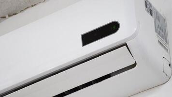 Turning On Air Conditioner, Adjusting Temperature on AC Unit, Beeping Sound from Remote Control, Modern Cooling System Operation, Energy Efficiency Demonstration video