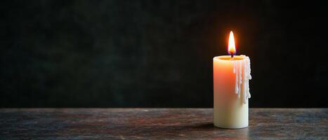 God's unconditional love for valentine's day concept. Single lit candle on a dark background, creating a warm ambiance. photo