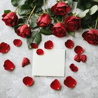 Valentine roses passion concept. Roses with petals surrounding a blank card on a textured surface. photo