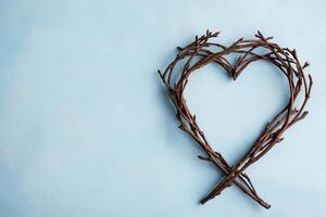 Love patience kindness for valentine's day concept. Natural twigs arranged in a heart shape on a light blue background. photo
