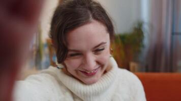 POV young woman girl making online selfie call talking waving hand hello, looking at camera video