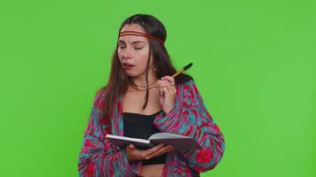 Woman making notes writing down thoughts with pen into notepad notebook diary, to do list, good idea video