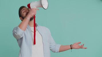 Man talking with megaphone, proclaiming news, loudly announcing advertisement pointing empty place video